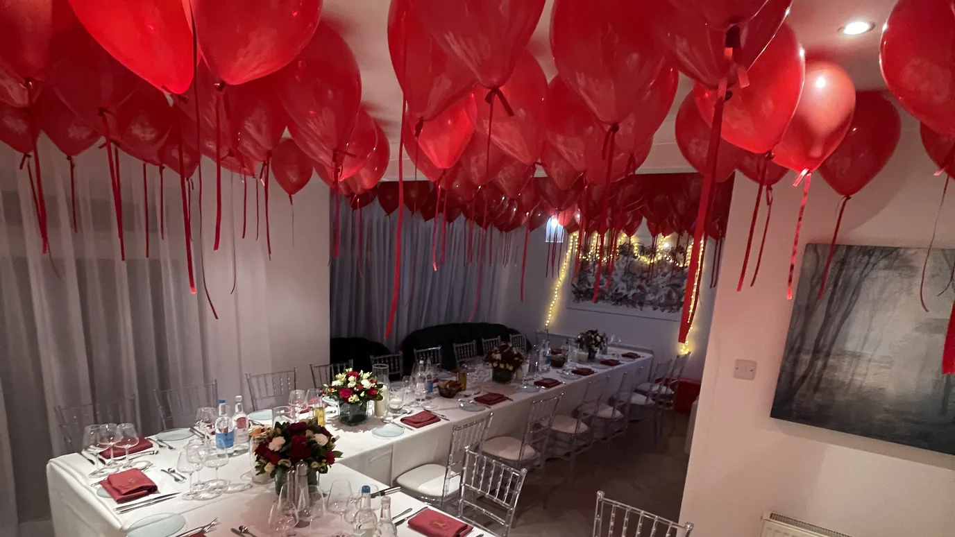 Private dining table set for a London dinner party with service staff in the room